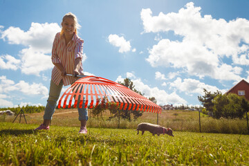 Unusual angle of woman raking leaves