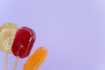 Closeup shot of lollipops on an isolated purple background