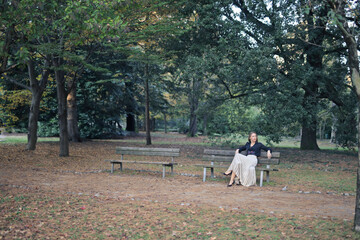 beautiful woman sitting on a bench in a park