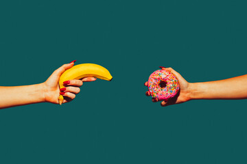 Banana and donut. Modern art collage in pop-art style. Hands isolated on trendy colored background...