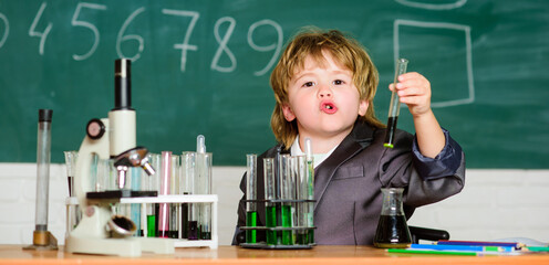 Biology school laboratory equipment. Little boy at the elementary school. little boy at lesson. Back to school. school kid scientist studying science. Always question, Always wonder