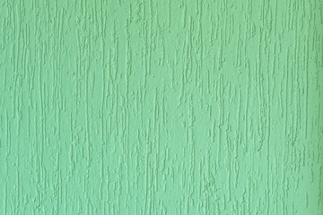 Plastered surface of a green grooved wall. In Brazil known as grafiato.