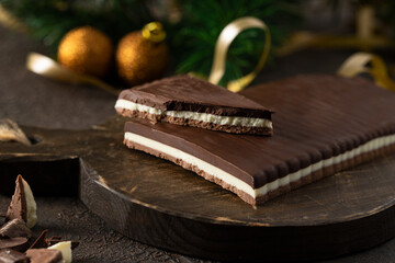 Three Chocolates Turron,  delicious and famous Christmas sweet on woodem rustic table with fir tree bunch