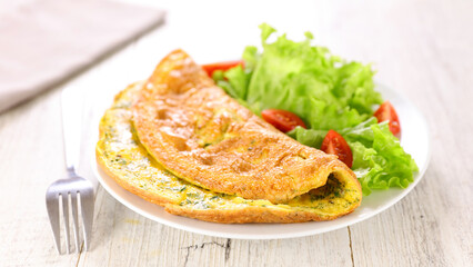 plate of omelet and salad