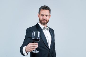 man wear office costume. formal event. businessman drink red wine. cheers for happy valentines day. alcohol drinking. handsome male on romantic date. unshaven man with wine glass. sommelier