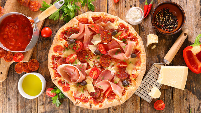 pizza with prosciutto ham, pepperoni, cheese and olive