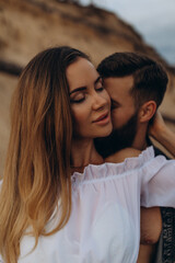 Fototapeta premium Romantic photo session of a young couple by the lake. Boy and girl summer walk.