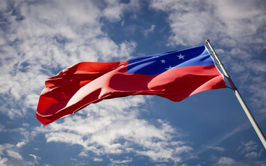 National state flag of Samoa fluttering at sky background.