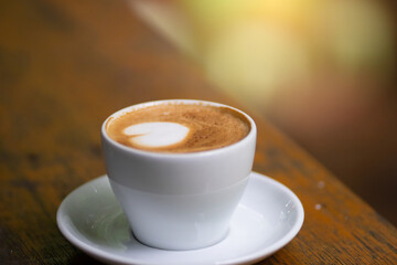 coffee cup and cake on wood table.