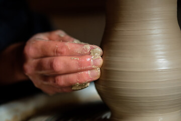 Fototapeta na wymiar Female hands working with clay on a potter's wheel