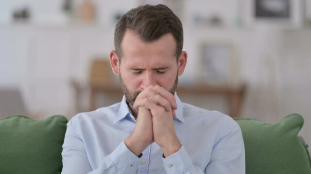 Hopeful Young Man Praying at Home