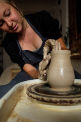 Woman making ceramic pottery on wheel, hands closeup. Concept for woman in freelance, business, hobby