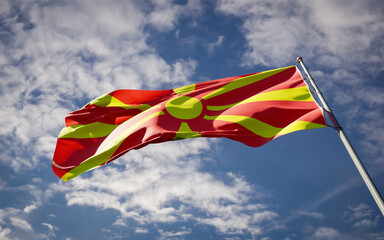 National state flag of Macedonia fluttering at sky background.