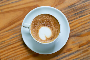 cup of coffee on wooden table