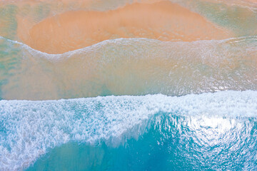 Fototapeta na wymiar (Top view) Beach seawater wave on sandy beach. Background and travel concept.