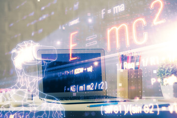 Desktop computer background and formula hologram writing. Double exposure. Education concept.