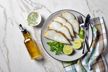 halibut fish slices on a plate, top view