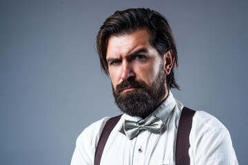 real gentleman. trendy man in suspenders and bow tie. confident and elegant man in classical wear. masculinity and charisma. formal party dress code. old fashioned bearded hipster