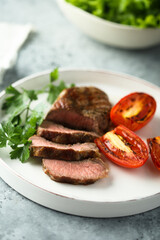 Beef steak with grilled tomatoes and parsley