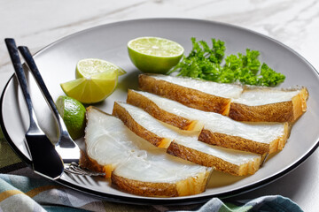 halibut fish slices on a plate, top view