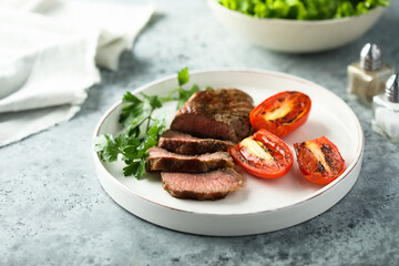 Beef steak with grilled tomatoes and parsley