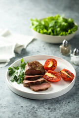 Beef steak with grilled tomatoes and parsley