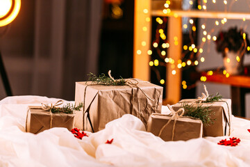 Craft gift box on the wooden table with garland