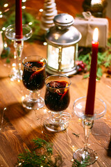 Festive decorated table with mugs of glintwine