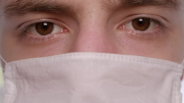 Close up of a man face wearing white cotton mask