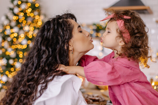 Christmas Mood Family At Home Cozy. Mom And Daughter Mix Race Oriental Kiss. Love Parenting Childhood. Lifestyle Small Moments Of Life. Motherhood Together Happy Offline