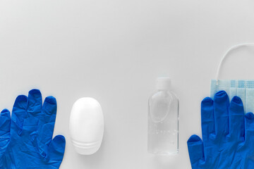 blue gloves, white soap, mask and antiseptic on a white background