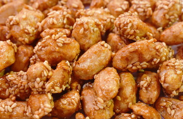 crispy sweet peanut coating syrup and dressing sesame in cup on table
