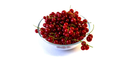 Isolated on white background red currant berries in a transparent plate