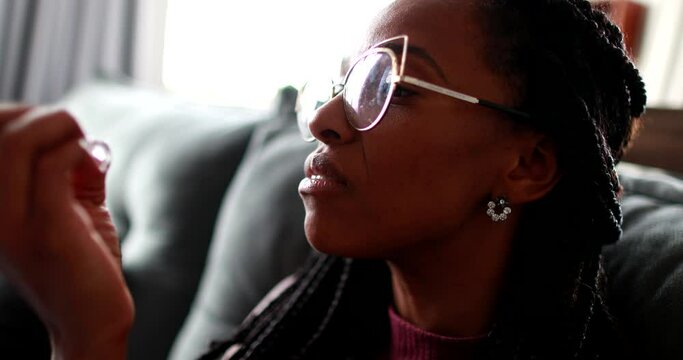 Anxious black woman biting nails