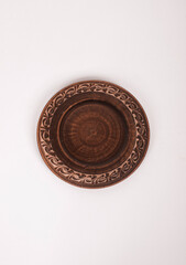 Ceramic ware isolated on a white background. Single rustic clay plate. 