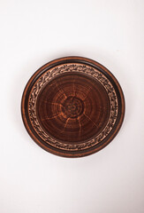 Ceramic ware isolated on a white background. Single rustic clay plate. 