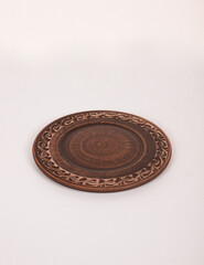 Ceramic ware isolated on a white background. Single rustic clay plate. 