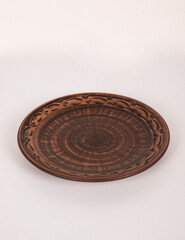 Ceramic ware isolated on a white background. Single rustic clay plate. 