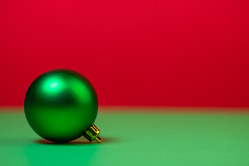 Green Christmas ball on a red background. Christmas decorations on a red background. Holiday decorations. Christmas concept.