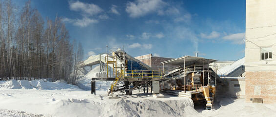 Panorama of stone crushing equipment in the mining enterprise in the winter sunny day on a...