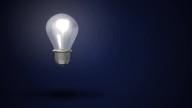 4k video of light bulb on blue background.