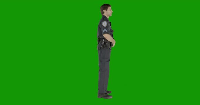 CHROMA KEY Caucasian male police officer standing against green screen. Model and property released for commercial use