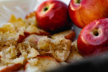 Collapsed soft baked apples in a white ceramic square shape on a special package. A white...