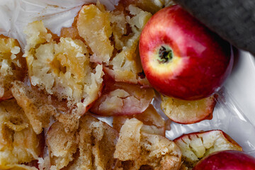 Collapsed soft baked apples in a white ceramic square shape on a special package. A white...