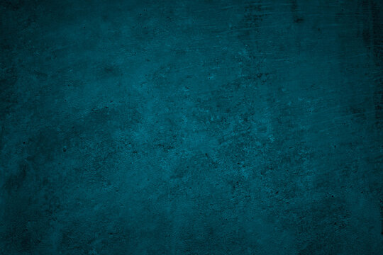 Blue green grunge background. Dark abstract rough background. Toned concrete wall texture. Combination of teal color and grunge texture.