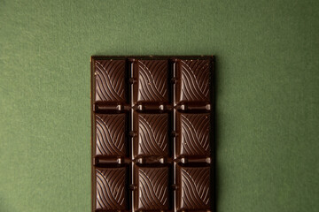chocolate bar on green color background