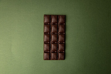 chocolate bar on green color background