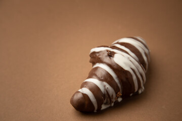 chocolate croissant on brown background