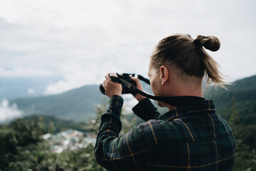 Man photographer standing on the high
