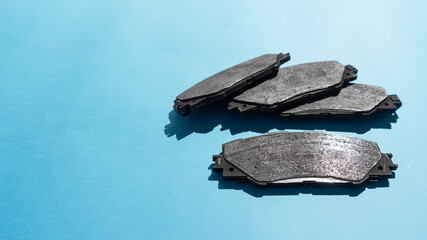 Old brake pads disk brake, isolated on a  background . A car used disc brakes pads.
